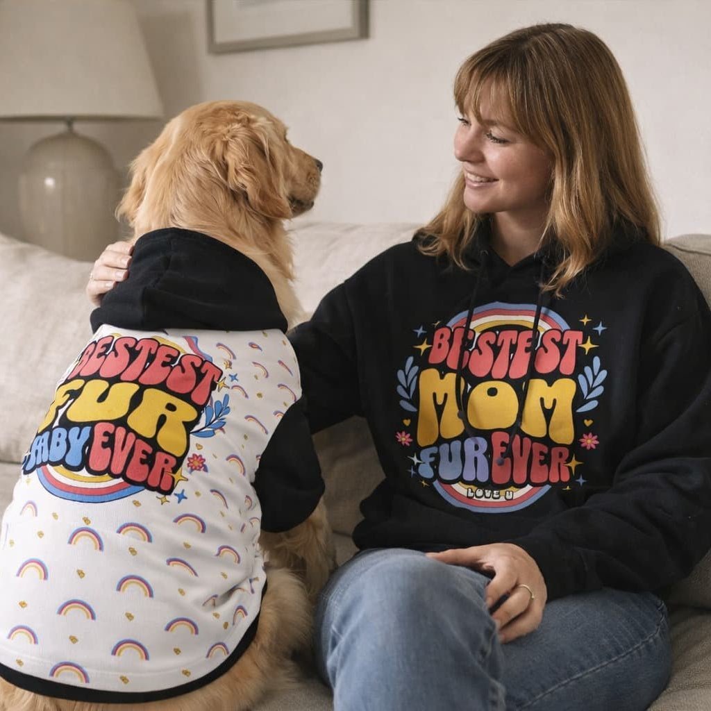 Woman and her dog sitting together wearing matching hoodies