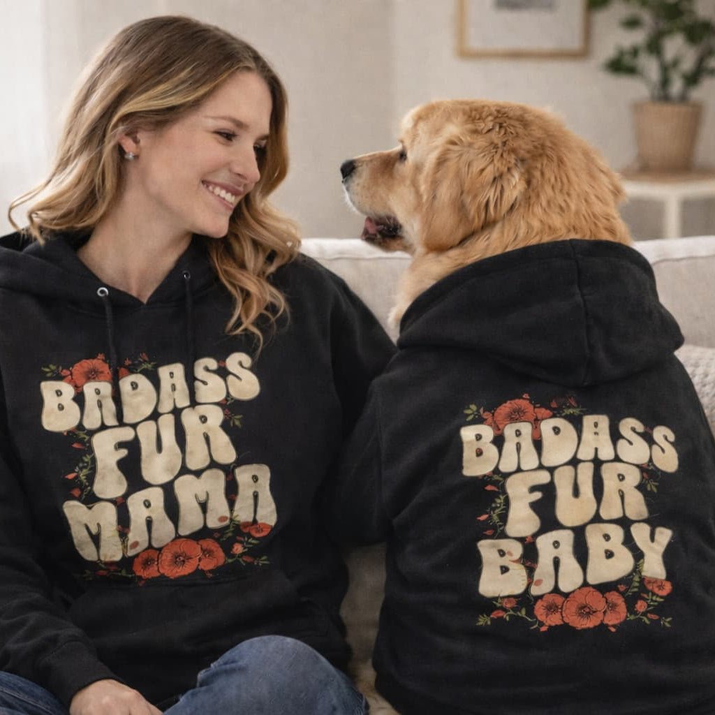 Woman and dog wearing matching black hoodies with 'BADASS FUR MAMA' and 'BADASS FUR BABY' text.