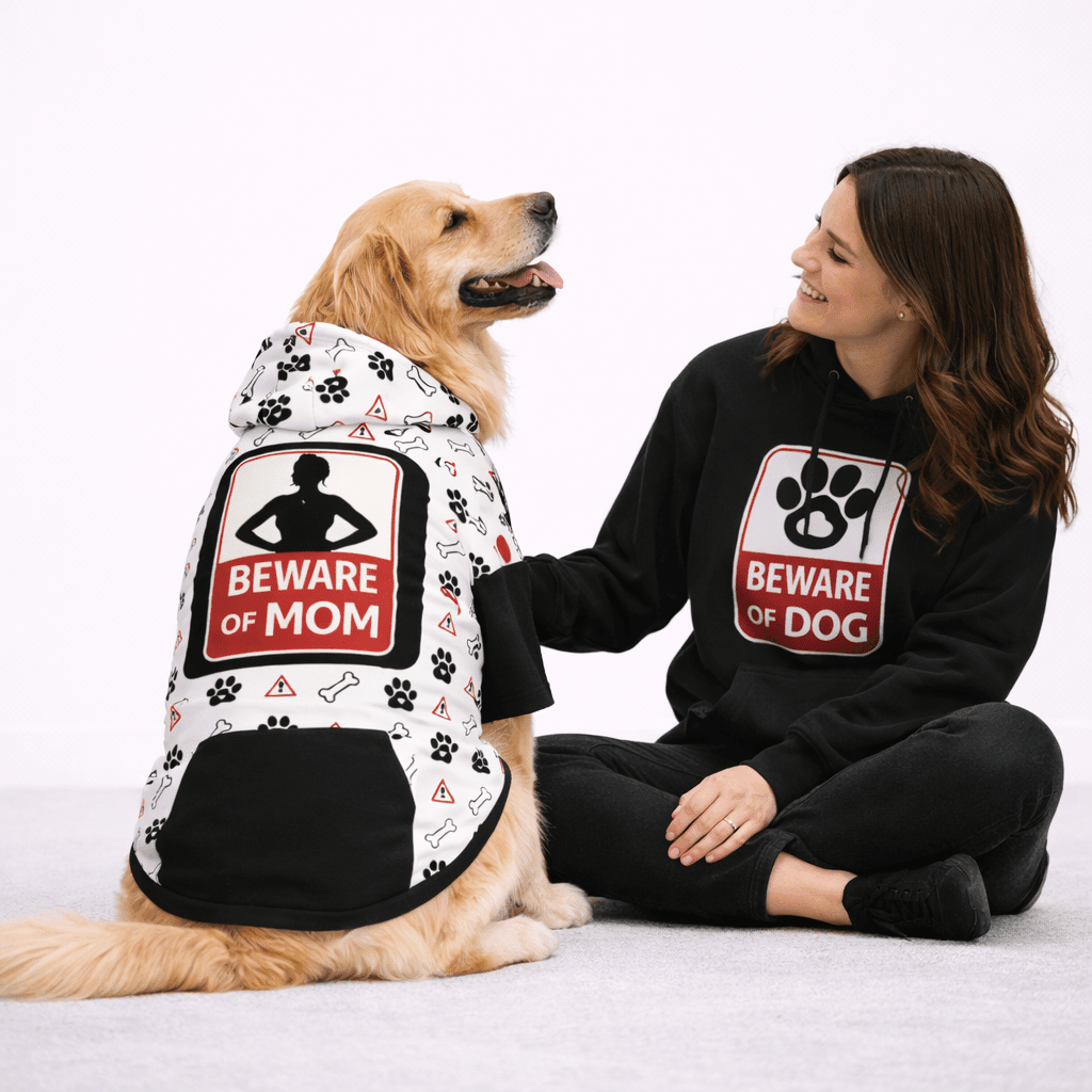 Woman and dog wearing matching 'Beware of Mom' and 'Beware of Dog' hoodies on a white background
