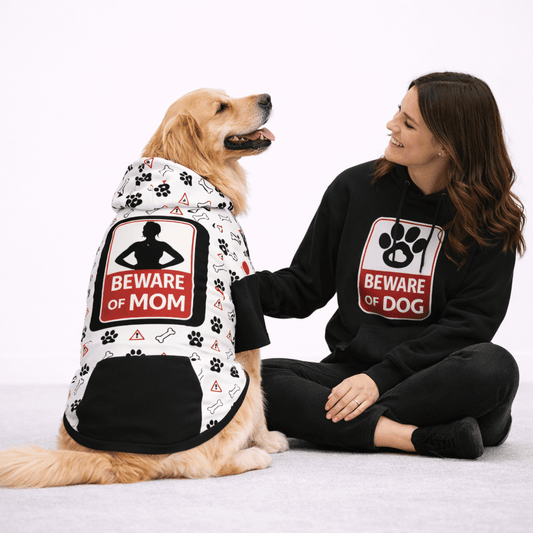 Woman and dog wearing matching 'Beware of Mom' and 'Beware of Dog' hoodies on a white background