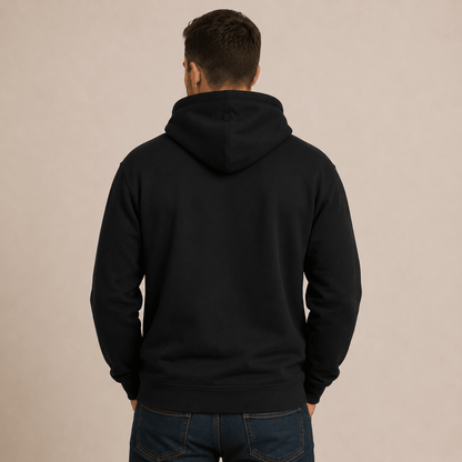 Person wearing a black hoodie from behind on a beige background