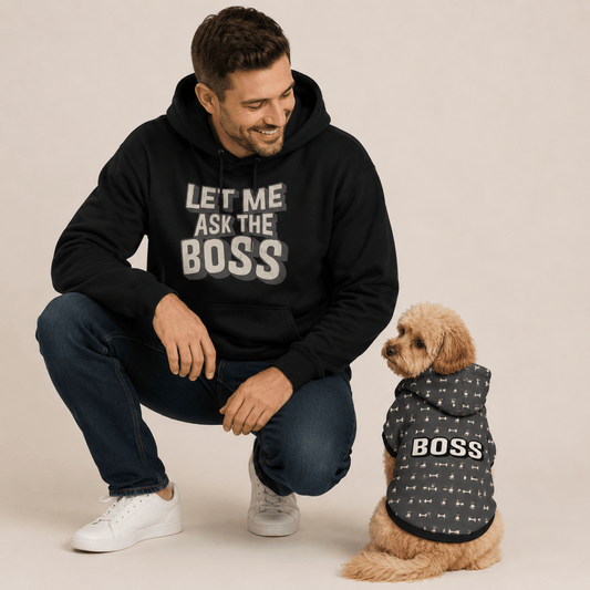 Man wearing a black hoodie with 'LET ME ASK THE BOSS' text, kneeling next to a dog in a matching 'BOSS' outfit.