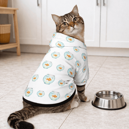 Cat wearing a white onesie with floral patterns in a kitchen