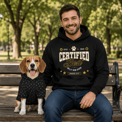 Man and dog sitting on a park bench wearing matching 'Certified Best' hoodies.