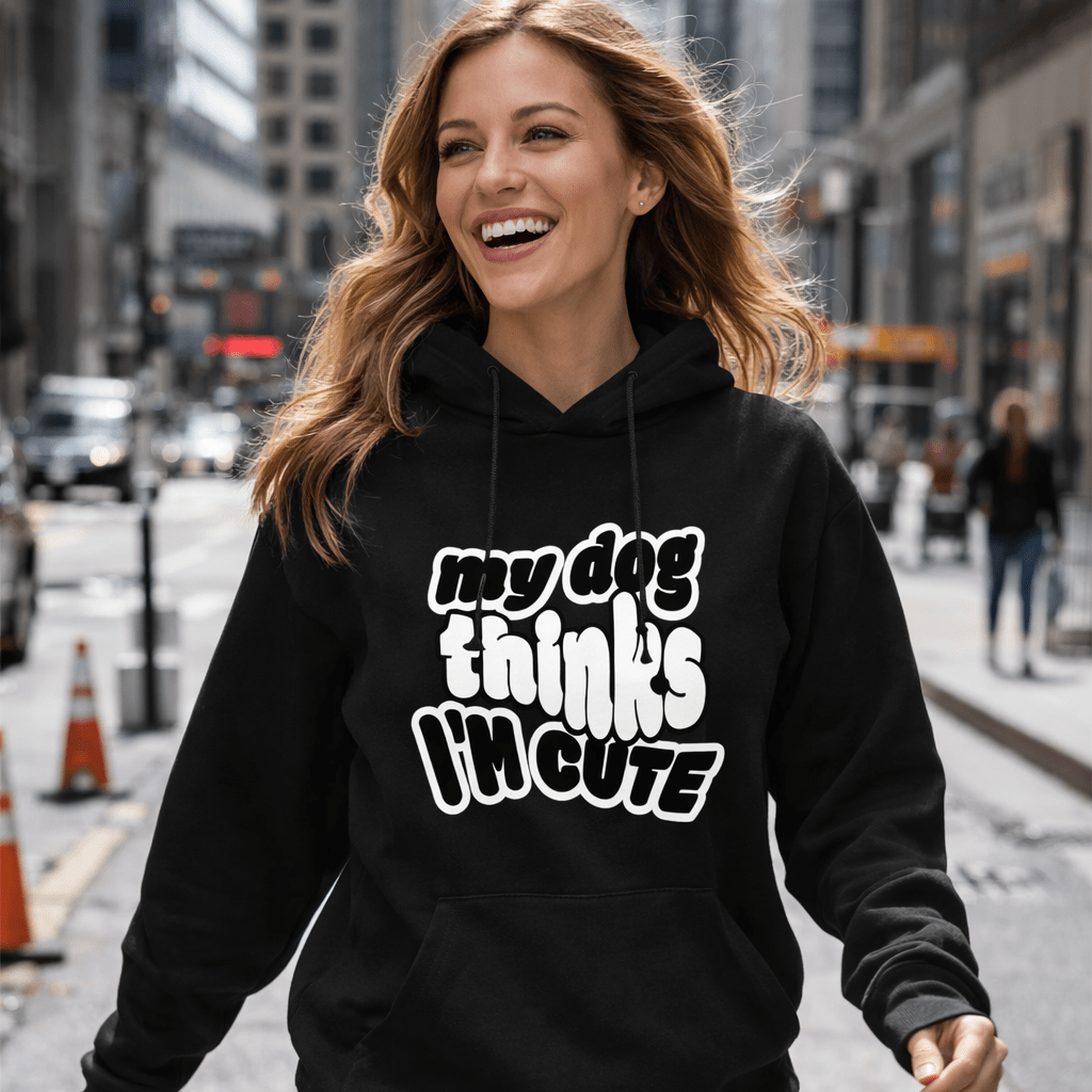 Woman wearing a black hoodie with text walking on a city street.