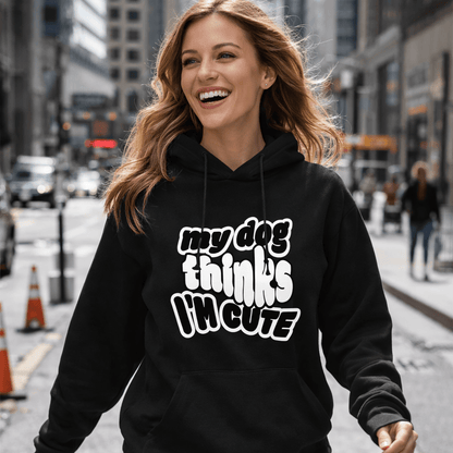 Woman wearing a black hoodie with text walking on a city street.