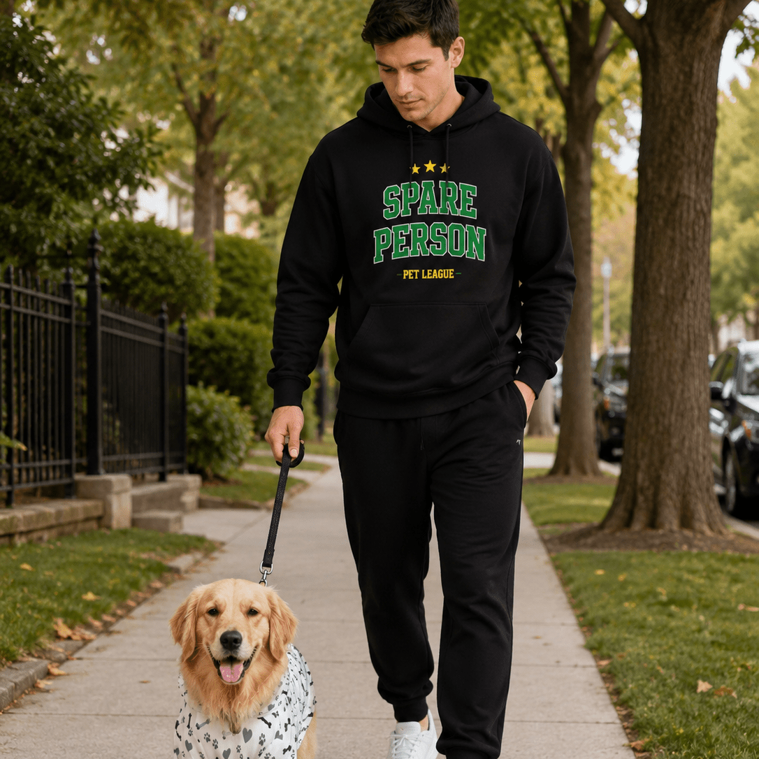 Man walking a dog on a leash in a park-like setting