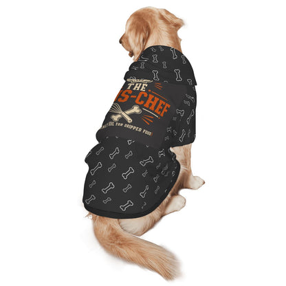 A golden retriever dog wearing a black pet shirt with a bone pattern and orange text that reads 'I Tasted Like a CS-CHEF'.
