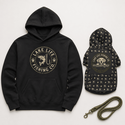 A black hoodie and matching black dog jacket set with a green leash, both featuring a circular 'Lake Life Fishing Co.' graphic on a light gray background.