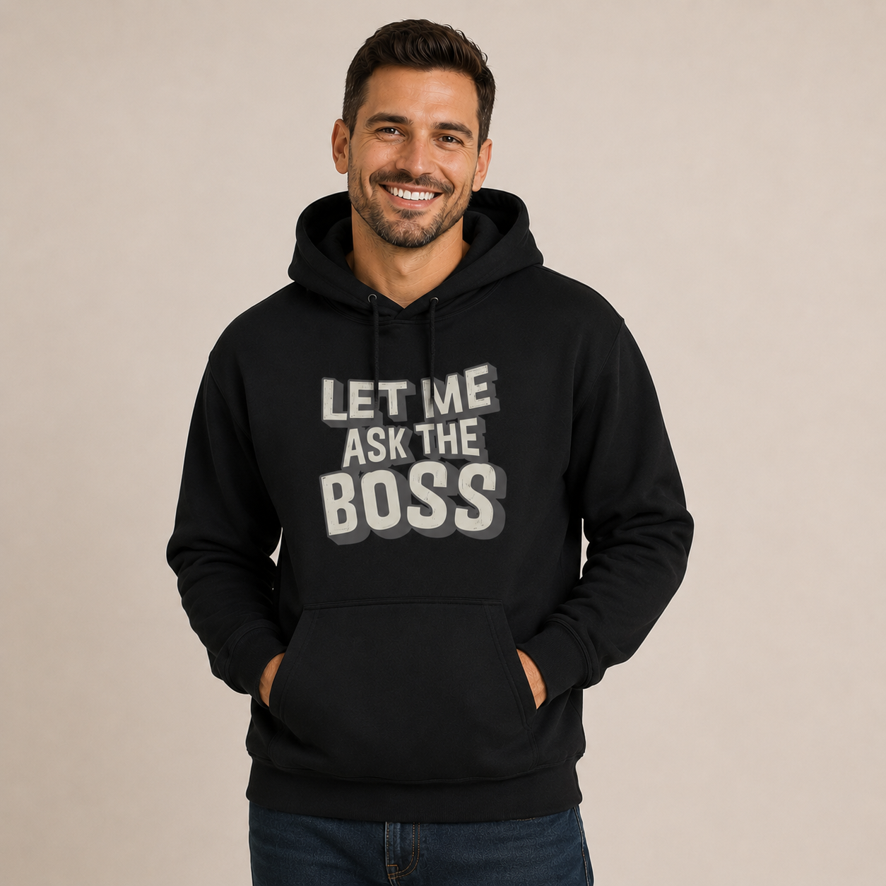 Man wearing a black hoodie with 'Let me ask the boss' text on a beige background