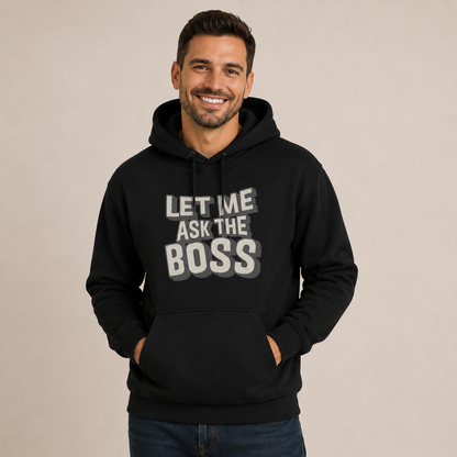 Man wearing a black hoodie with 'Let me ask the boss' text on a beige background