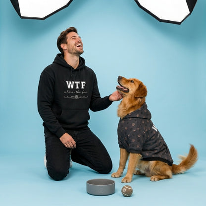 Man in black hoodie with 'WTF' and dog in patterned coat on blue background